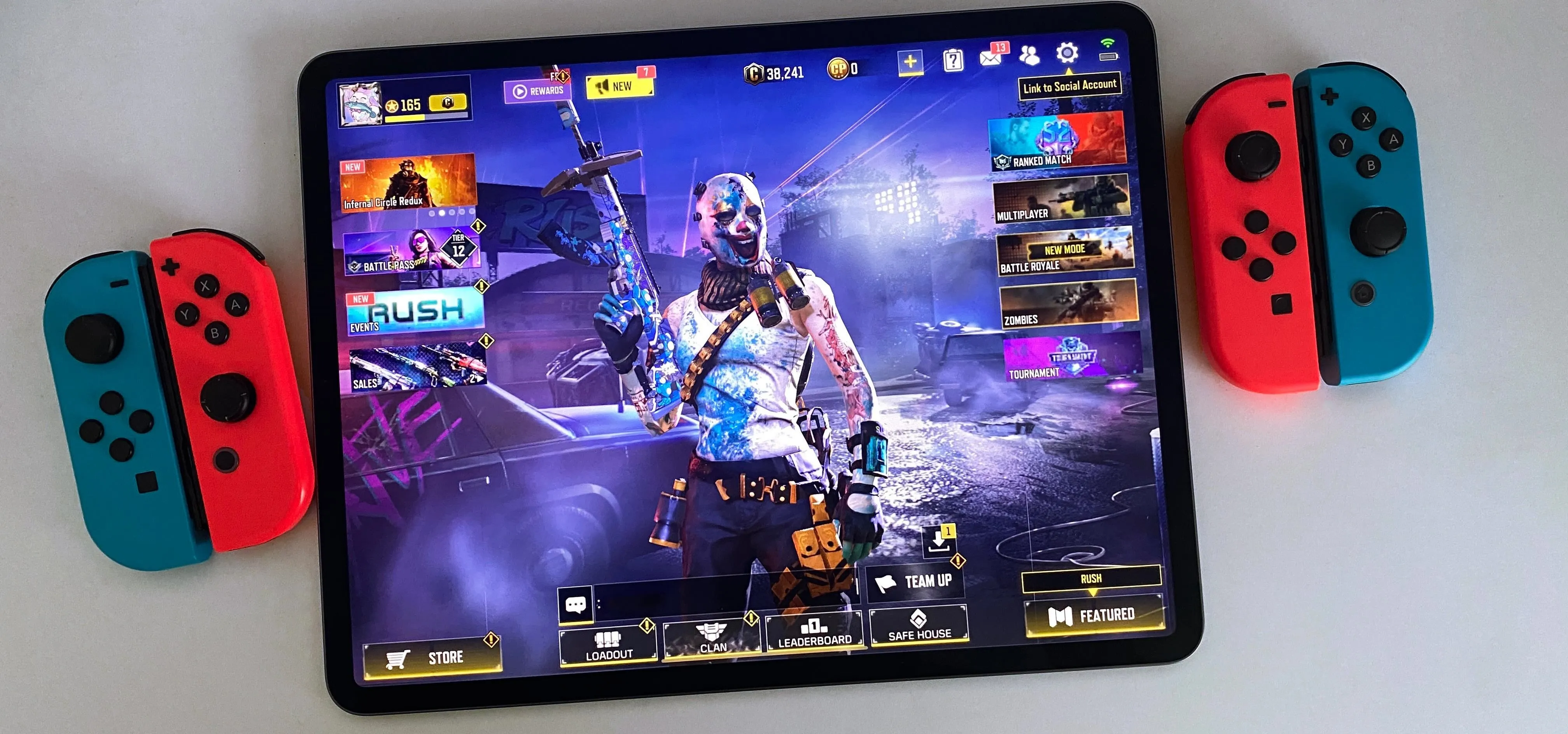 Gaming tablet with controllers displayed alongside a character in a multiplayer video game.