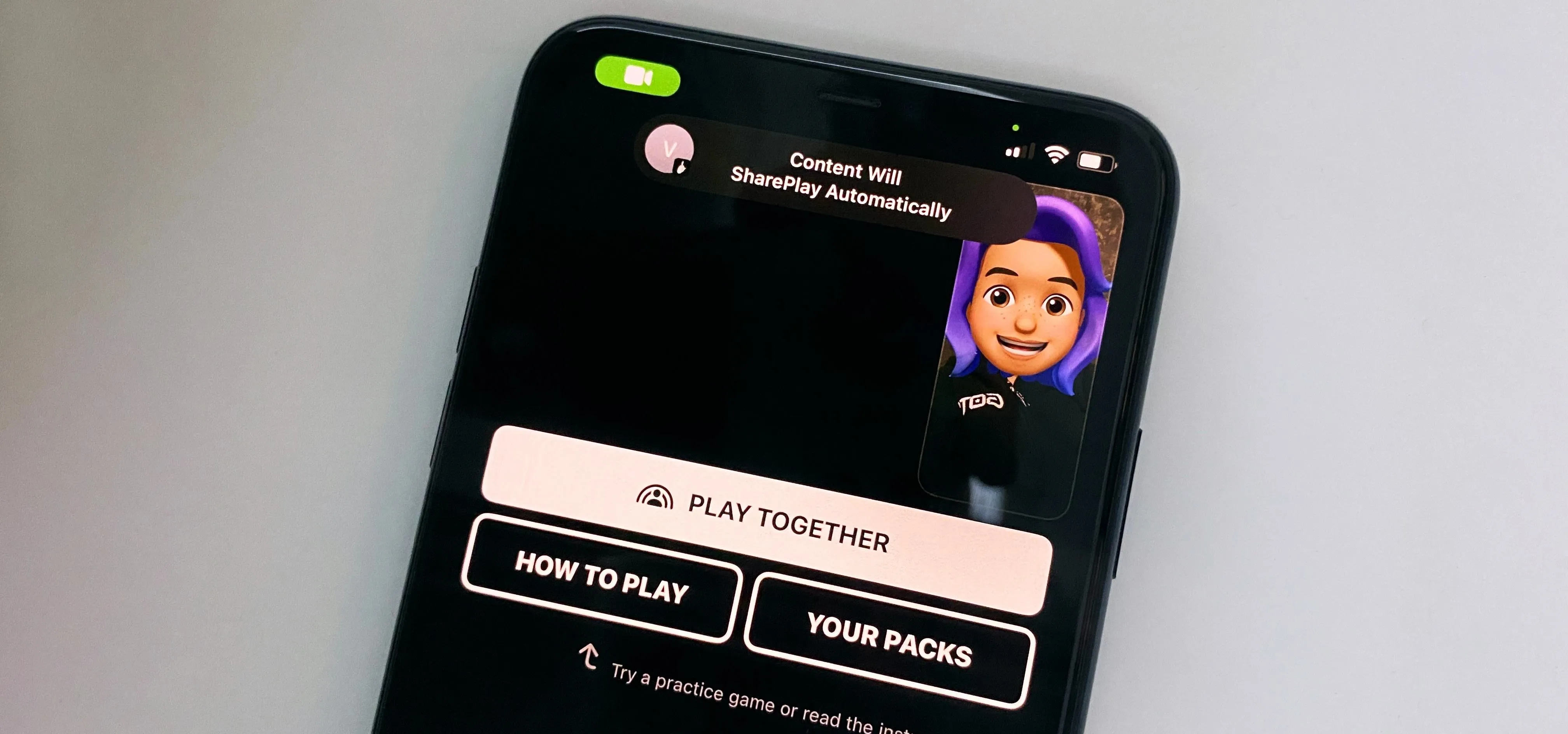 Mobile phone displaying a game interface with user avatar and options to play.