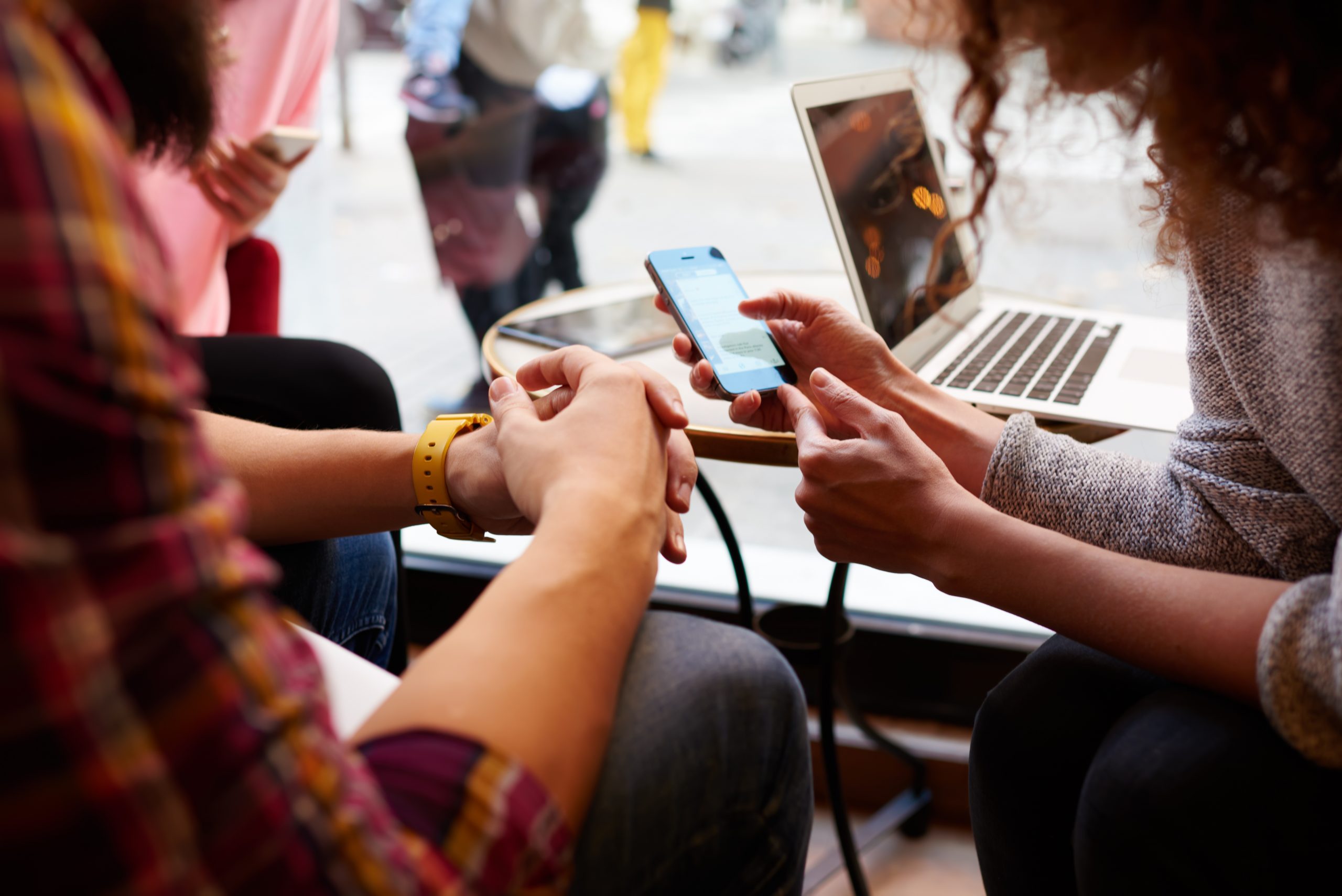 Vertical explainer photo 4 - Two people look at a cell phone / Photo Credit: GaudiLab, Shutterstock