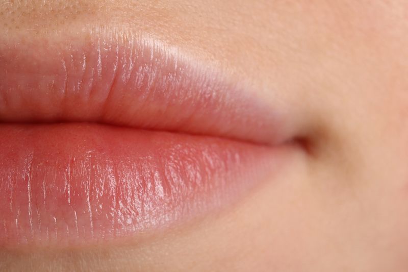 A macro photo showing a close up image of a woman's lips. 