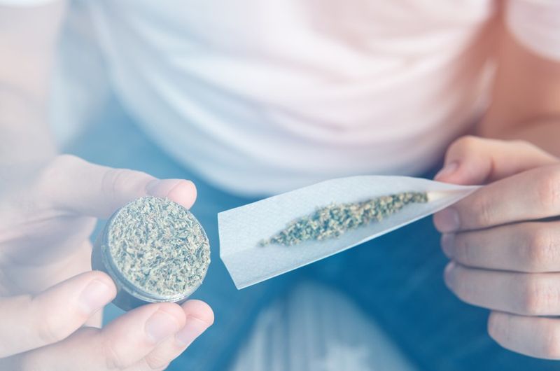 Man rolling a cannabis joint