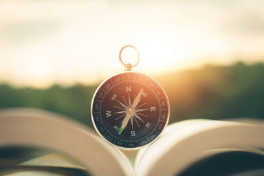 Compass on mountain at sunset