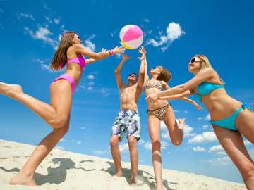 Young people playing ball on the beach online puzzle