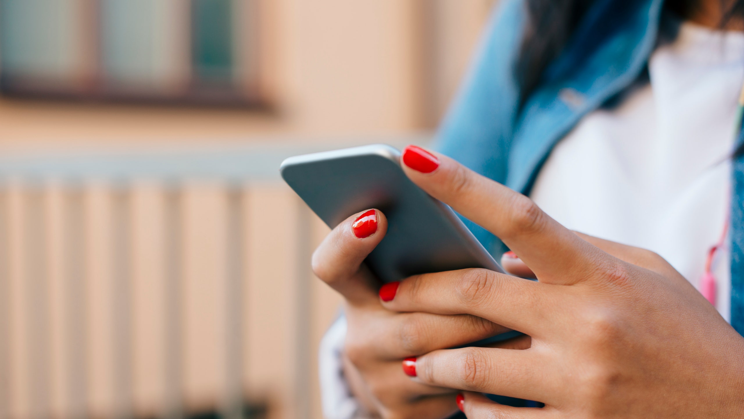 Cropped image of teenage girl using mobile phone