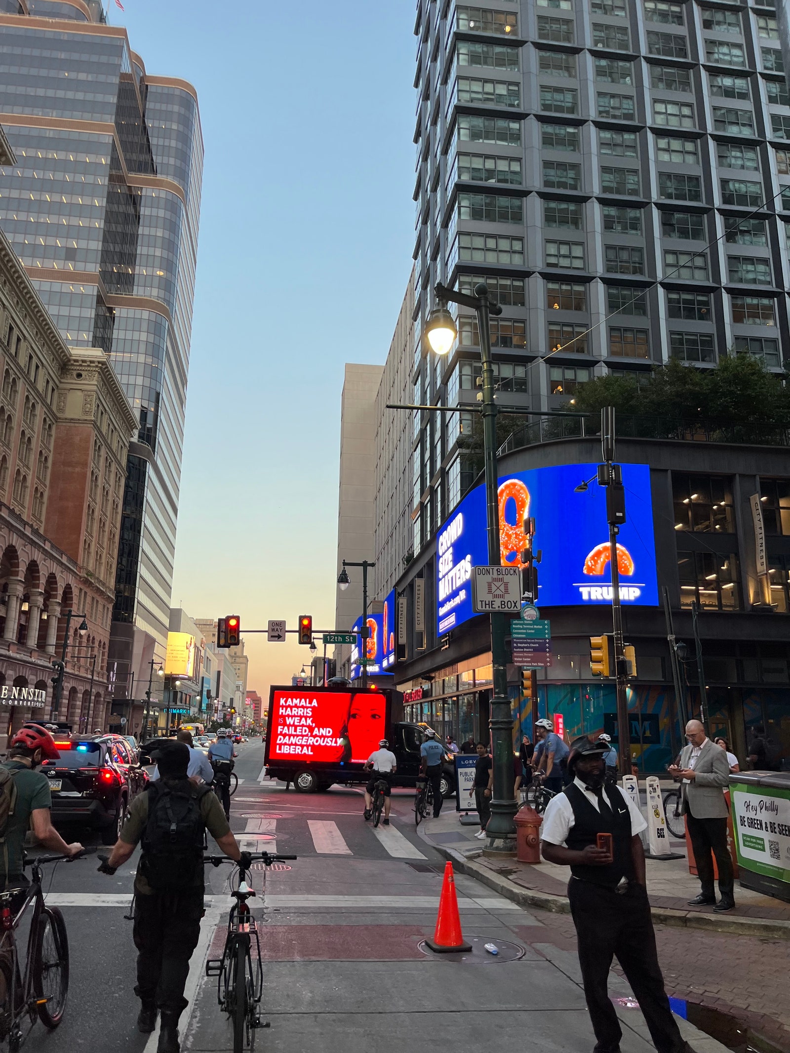 A Trump van calling VP Kamala Harris “weak failed and dangerously liberal” passes under a proHarris antiTrump billboard...