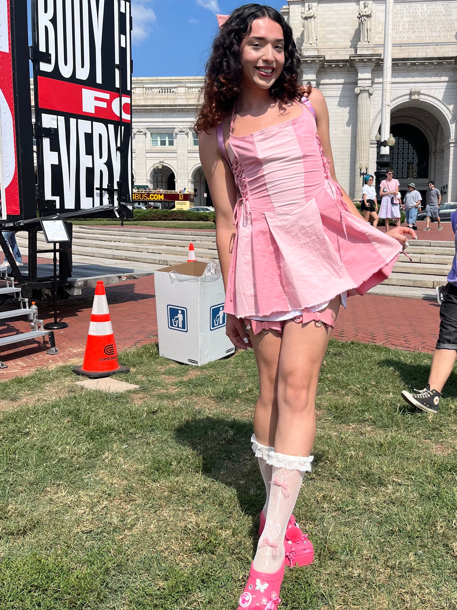 Ale in a pink dress and shoes at the Gender Liberation March