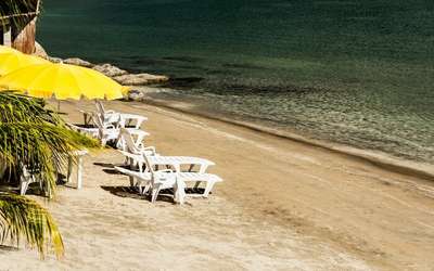 Yellow parasol recliners on Subic Bay beach