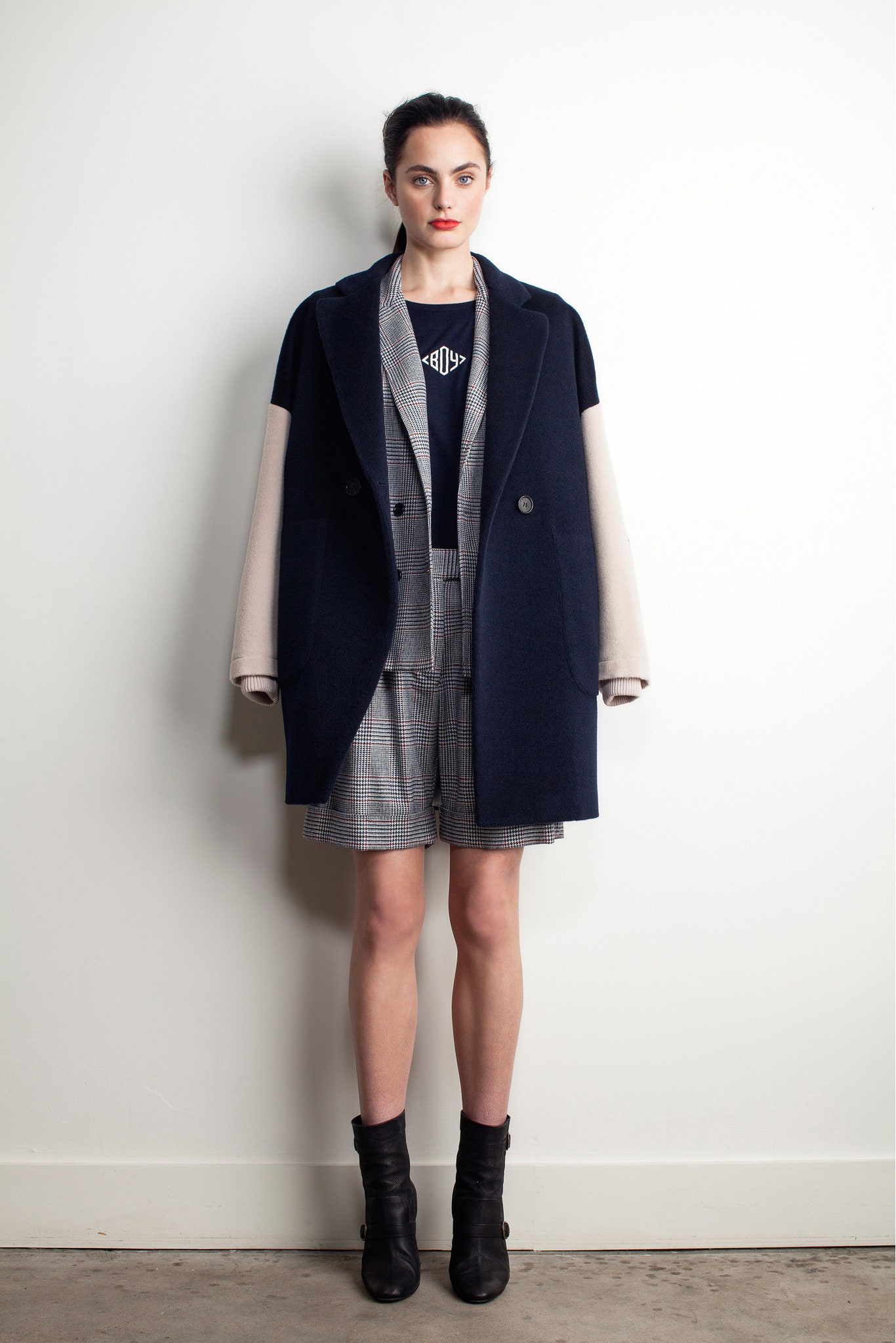 Image may contain Coat Clothing Apparel Human Person Overcoat Female Suit Trench Coat Dress and Sleeve