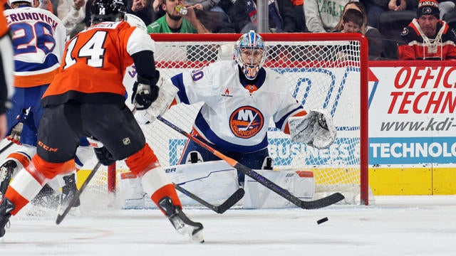 Goaltender Ilya Sorokin #30 of the New York Islanders tracks the loose puck as Sean Couturier #14 of the Philadelphia Flyers anticipates a scoring chance at the Wells Fargo Center on January 30, 2025 in Philadelphia, Pennsylvania. 