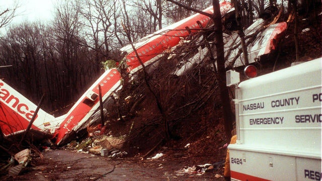 Scene of Avianca Flight 52 lying on a hillside in Cove Neck, New York on January 26, 1990 after crashing when it ran out of fuel with 158 people on board the night before. There were 73 fatalities. A Nassau County emergency services vehicle is in the foreground. 