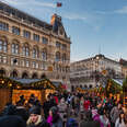 christmas market in Vienna, Austria with buildings and wreaths 