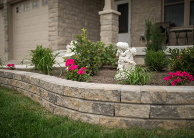 Raised flower bed with brick retaining wall