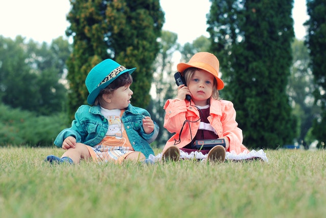 Baby girls sitting on the ground