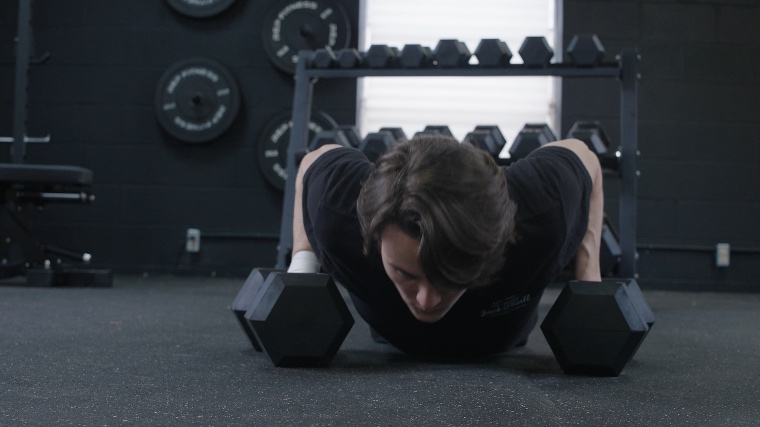 A BarBend tester doing Push-ups with the REP Fitness Hex Dumbbells.