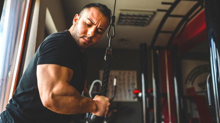 Muscular person working out in the gym.