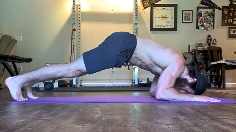 A person performing the bodyweight skull crusher exercise.