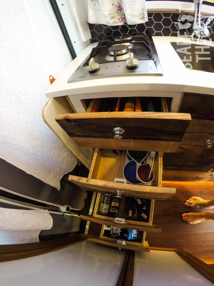 Drawers in the galley open to show storage space in Kristen's first 4x4 merecdes sprinter van