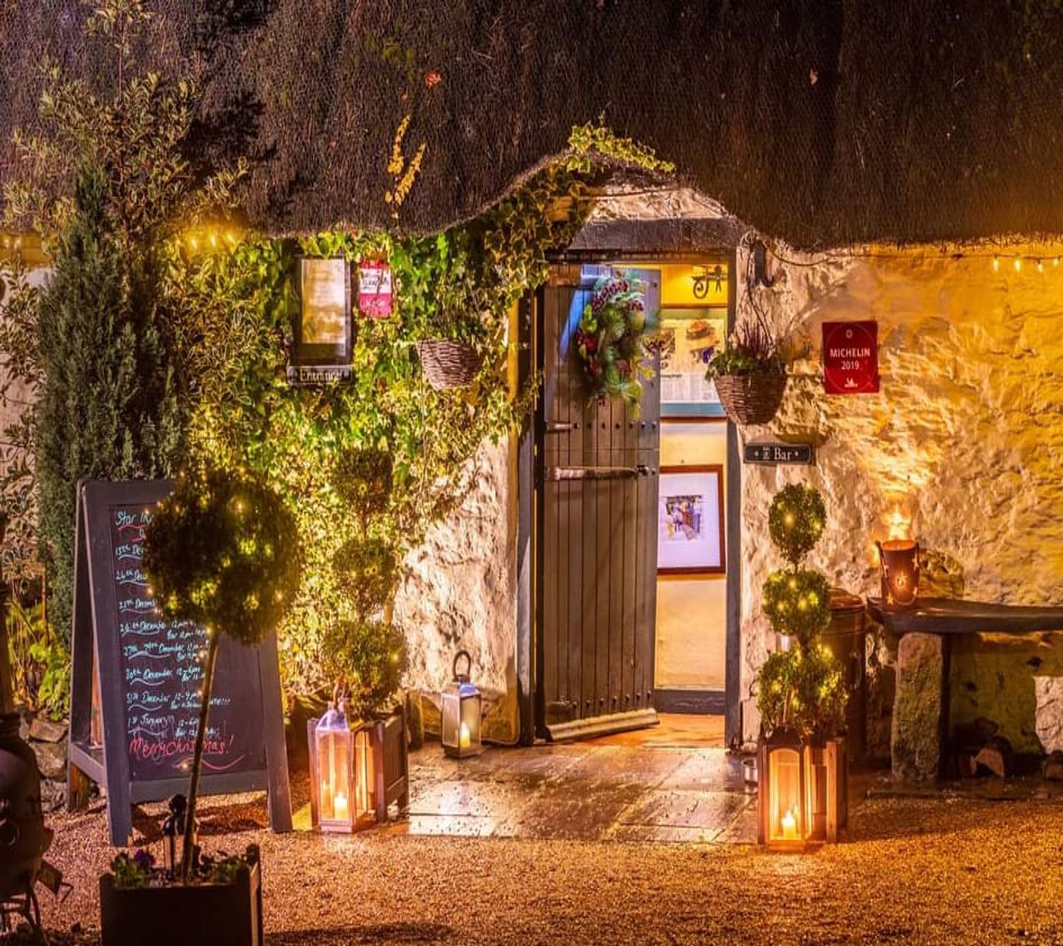 An illuminated whitewash entrance to The Star Inn Harome.