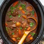 overhead beef stew in crockpot with ladle