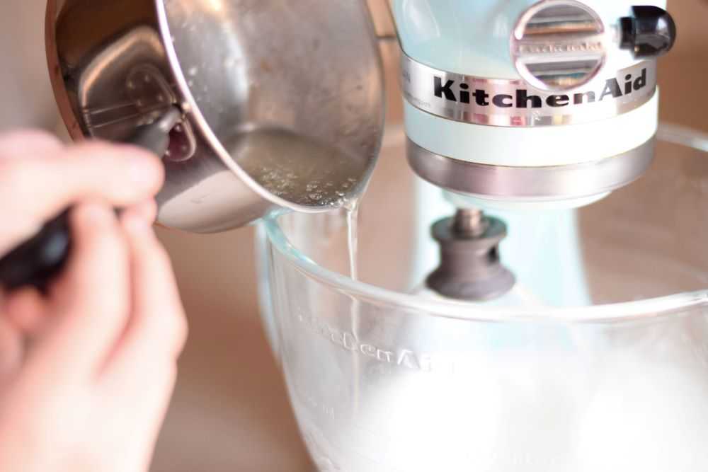 Slowly pour the hot syrup into the beaten egg whites