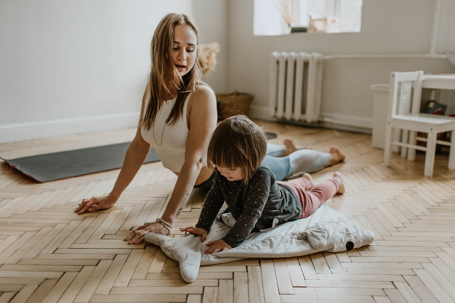 21 Day Fix Workout Order a Woman and a Child Doing Yoga on the Floor of a Home