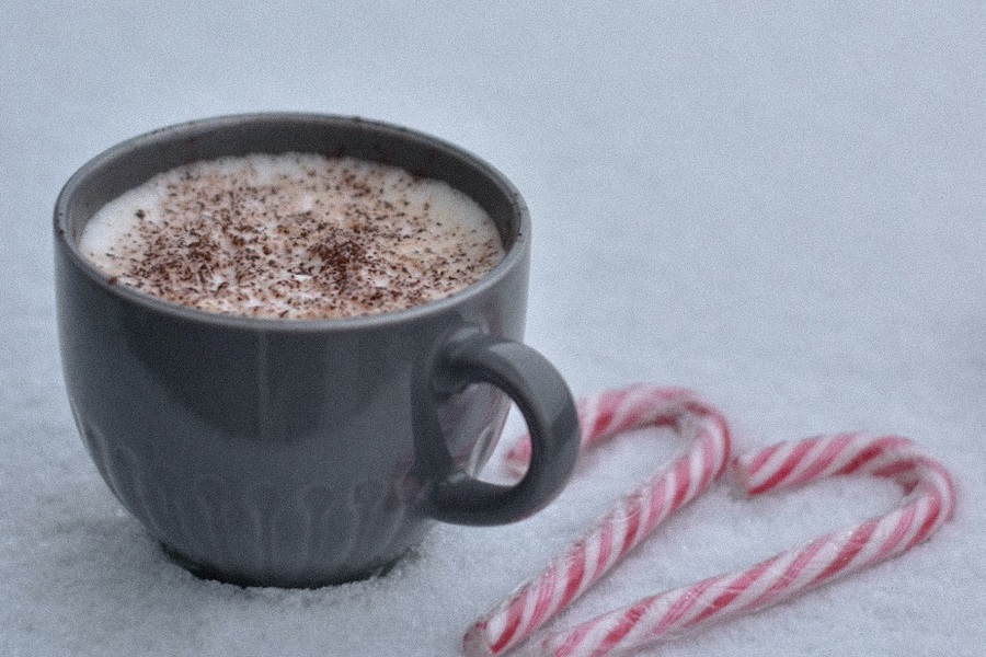 Slow Cooker Spiked Peppermint Hot Chocolate Recipes a Cup of Hot Chocolate in the Snow with Candy Canes Next to it