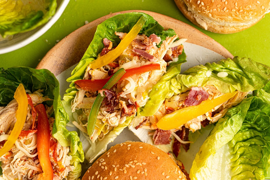 Crockpot Chicken and Bacon Keto Overhead View of Chicken Lettuce Wraps and Sandwiches on a Wooden Plate