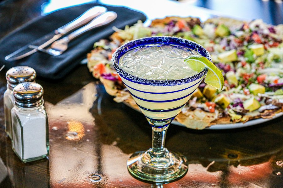 Margarita Pitcher Recipes Close Up of a Margarita Next to a Plate of Nachos