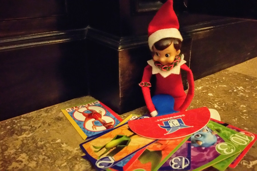 Elf on the Shelf Activities An Elf Playing Games on a Kitchen Counter