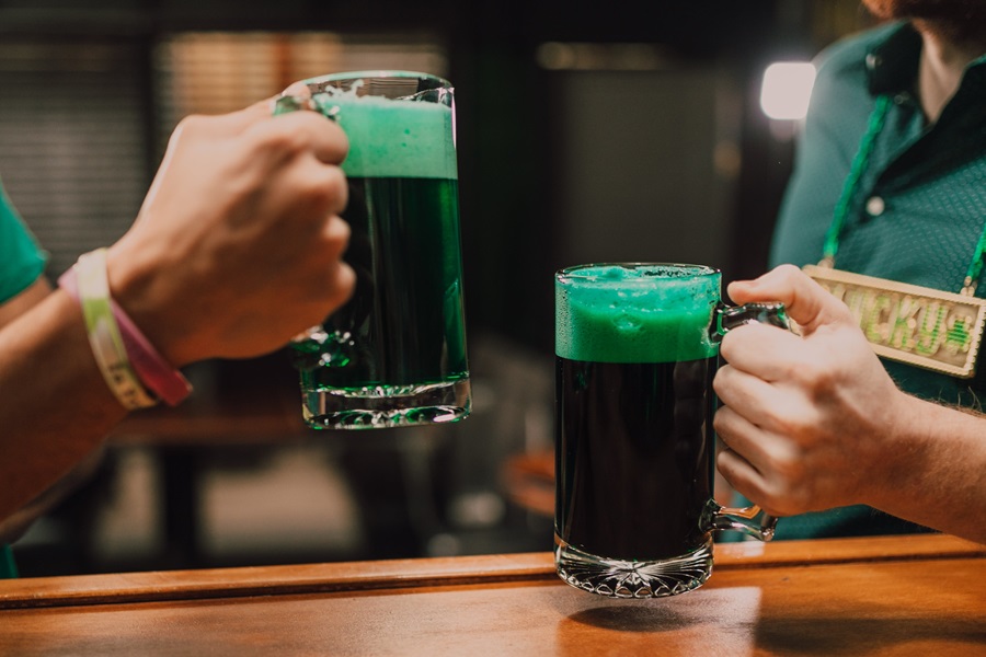 Green Foods for St. Patrick's Day Close Up of Two Glasses of Green Beer Being Held by Two People