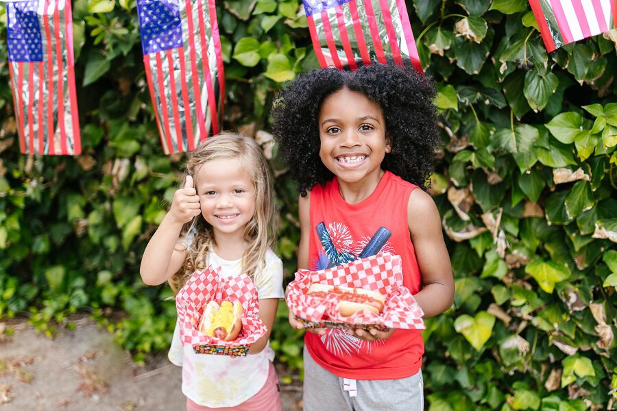 4th of July Party Ideas Two Young Girls at a Fourth of July Party Holding Food