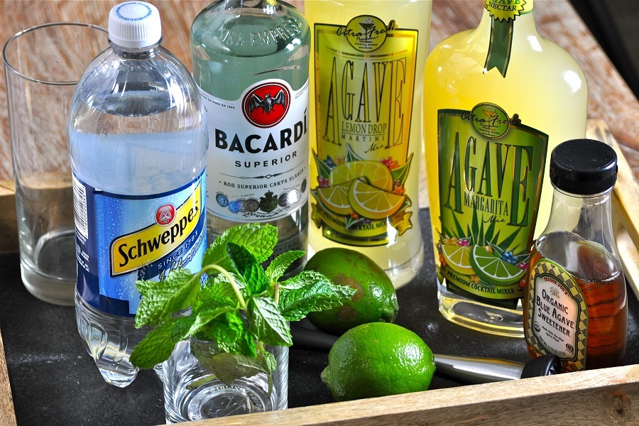 Party Drinks a Bottle of Barcardi and Cocktail Mixers. Limes and Mint Sprigs on a Serving Tray