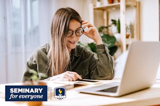 A student happily engaged in study at home.