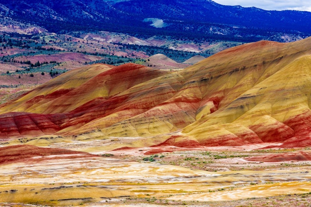 Colorful hills and larger mountains in background