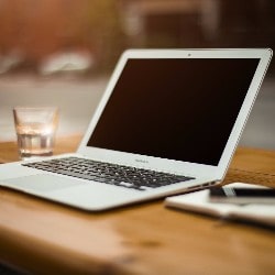 A laptop sitting on a desk.