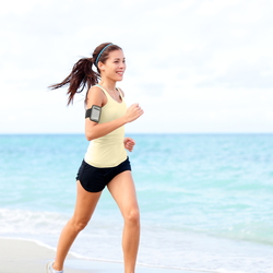 A person running on a beach, representing the idea of hosting a remote fun run.