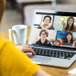 A person attending a virtual meeting on their laptop, representing the idea of a live-streamed Q&A fundraiser.