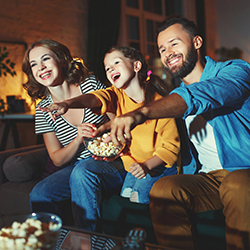 A family laughing, representing comedy nights as a fundraising idea.