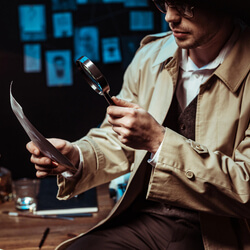 A detective looking through a magnifying glass, representing the concept of a murder mystery dinner.