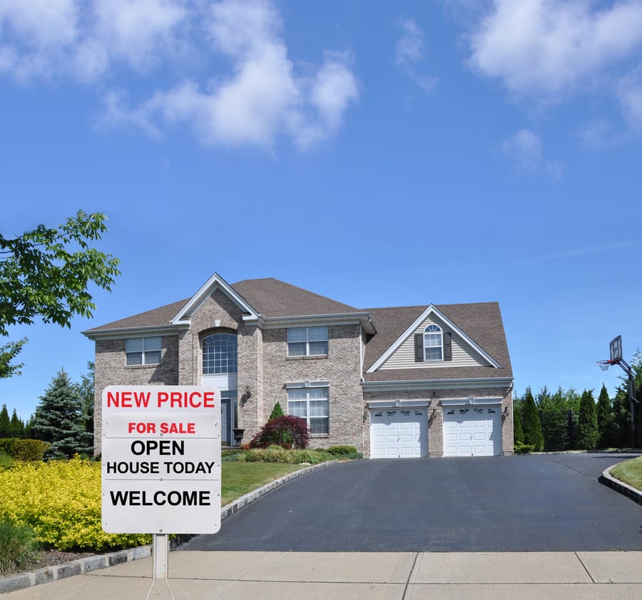 home for sale with sign and open house sign