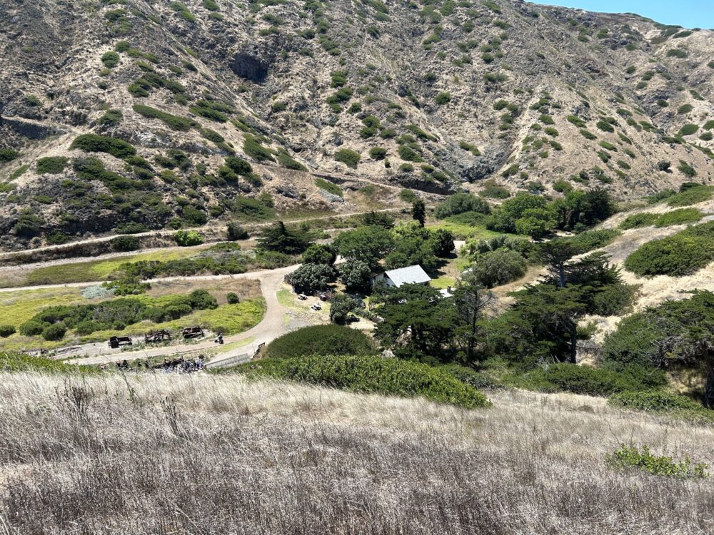 Panoramic view of a few buildings in a valley.