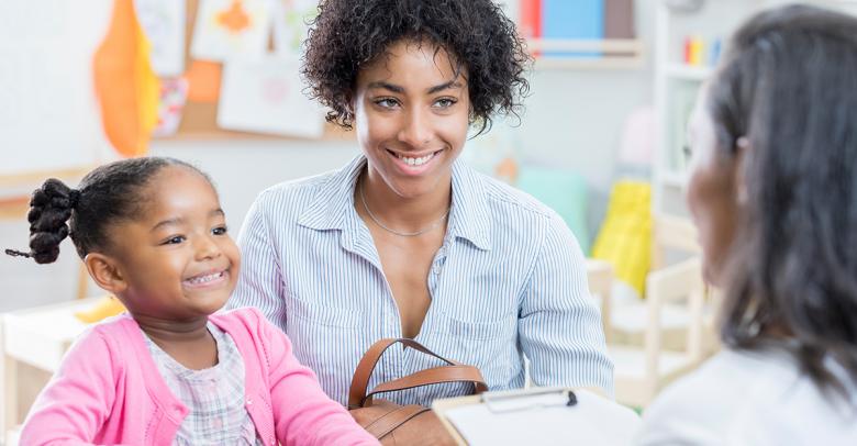 teacher meeting with parent and early childhood student