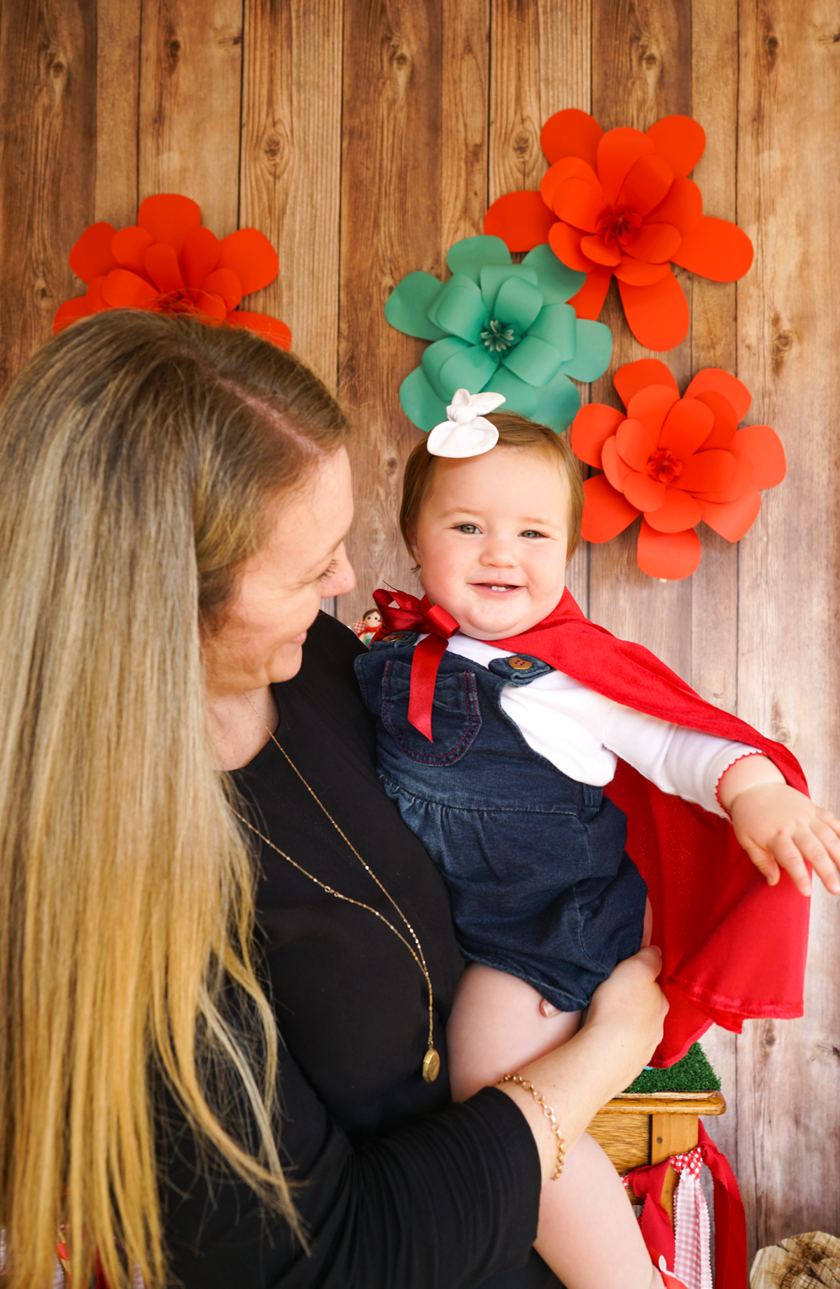 Little Red Riding Hood Party Outfit of a red hooded cape with a big red silk bow to finish it off. 