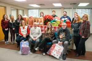 Herkimer College students, faculty, and staff pose with holiday gifts