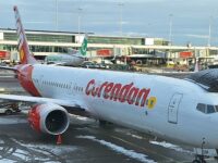 Corendon 737 MAX at a gate, partially covered with snow