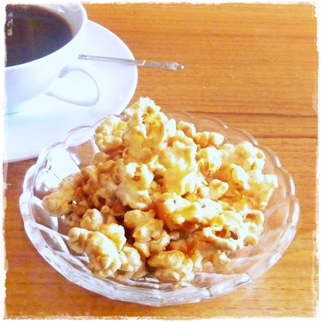 bowl of buttered popcorn and a coffee