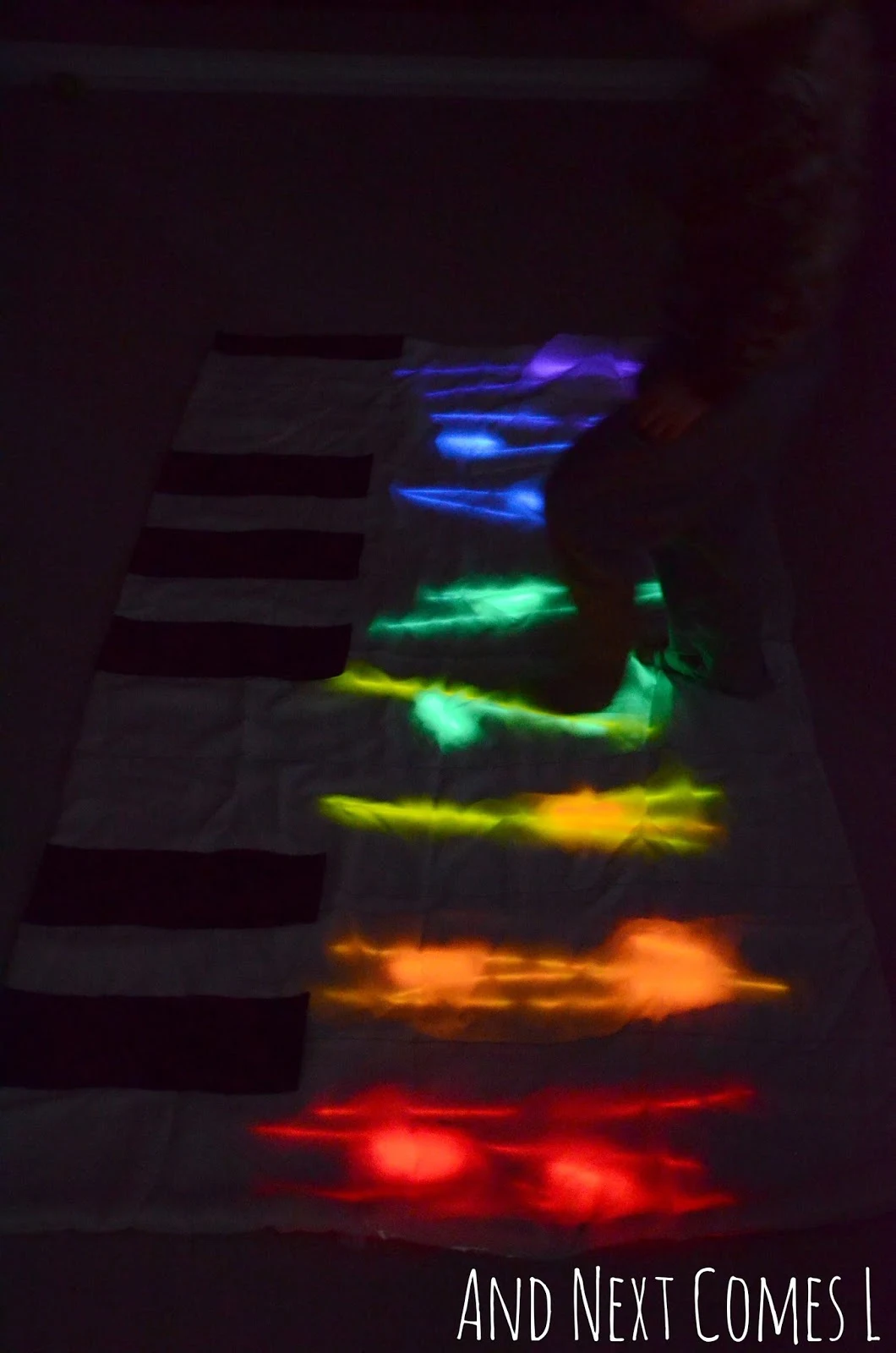 Gross motor play on a homemade glowing floor piano from And Next Comes L