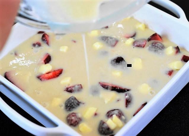 Pouring Batter for Strawberry Cobbler Topping Image