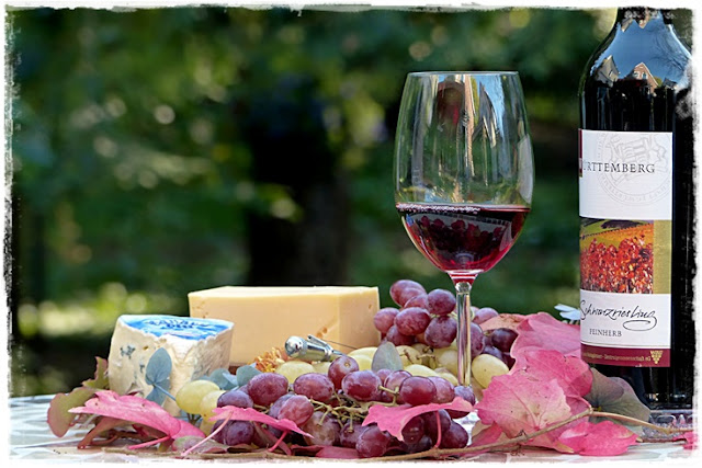 spontaneous lunch of cheese, bread, wine, fruit, nuts and accompaniments