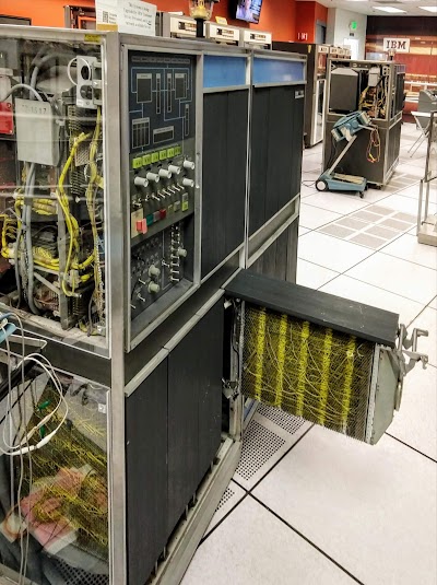 The IBM 1401 with gate 01B4 opened. The yellow wire-wrapped wiring connects the circuit boards that are plugged into the gate. The computer's console is visible on the front of the computer.